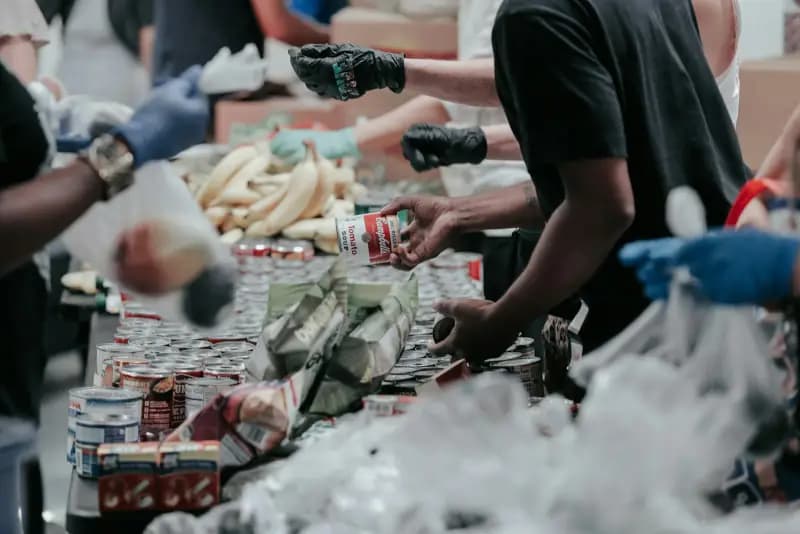 Volunteers sorting donated food at a community food bank