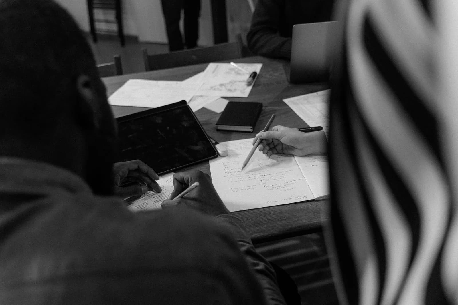 A team reviewing plans, notes and project documents together.