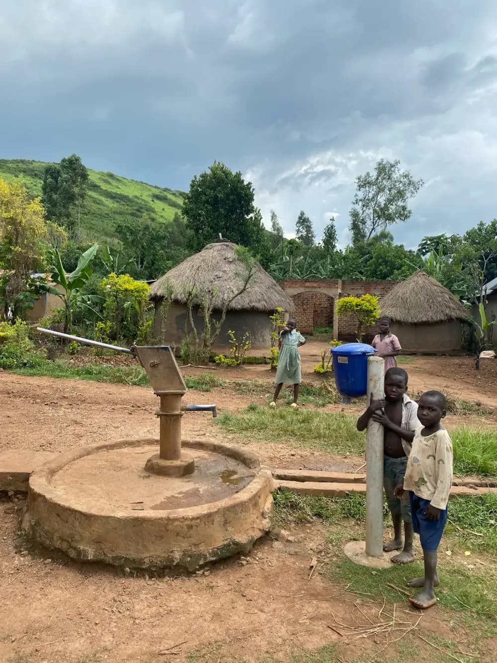 A hand-operated water pump in a rural setting